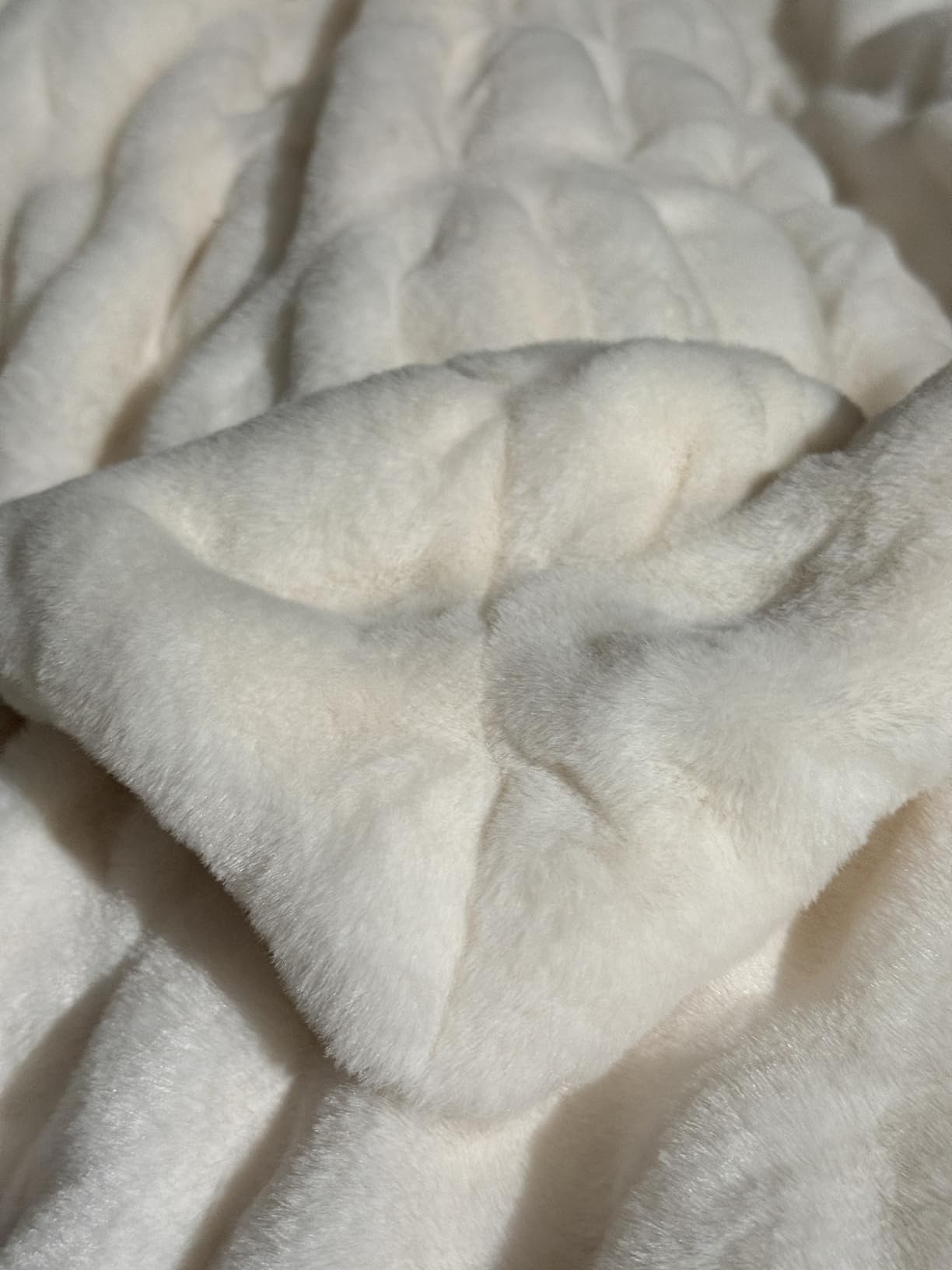 Close-up of pillowy-soft textured white Aruva SereneWeave throw fabric